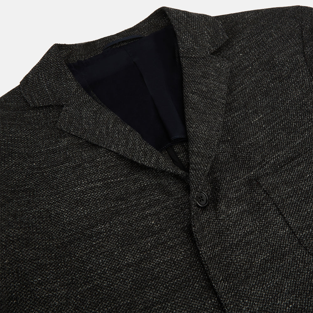The Charcoal Linen Blend Cambridge blazer by Turnbull & Asser features British tailoring with a notched lapel, two front buttons, and three pockets, shown against a plain white background.