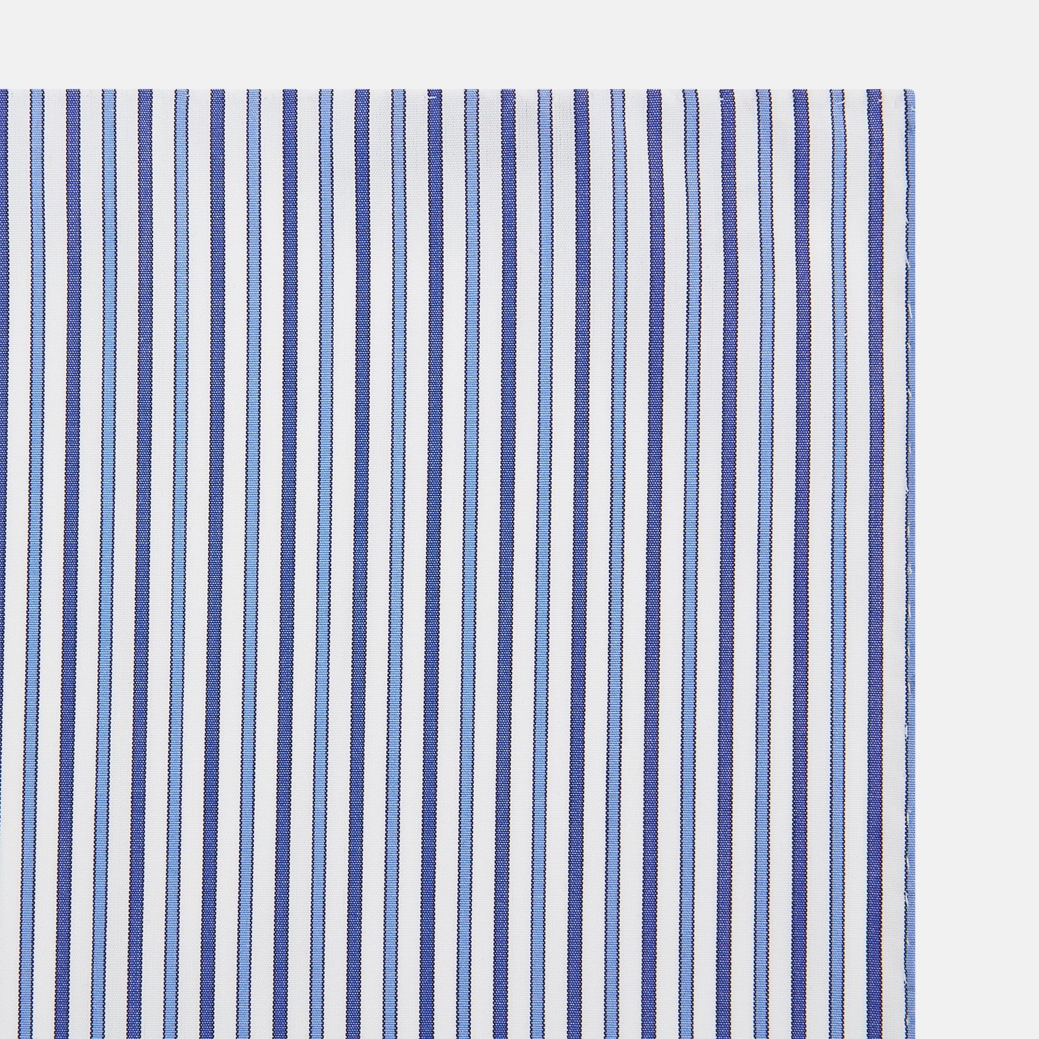 View 2 of product The Turnbull & Asser Navy and Blue Multi Stripe Handkerchief features a classic cotton pinstripe pattern—vertical blue and white stripes—making it a versatile and elegant formal accessory.