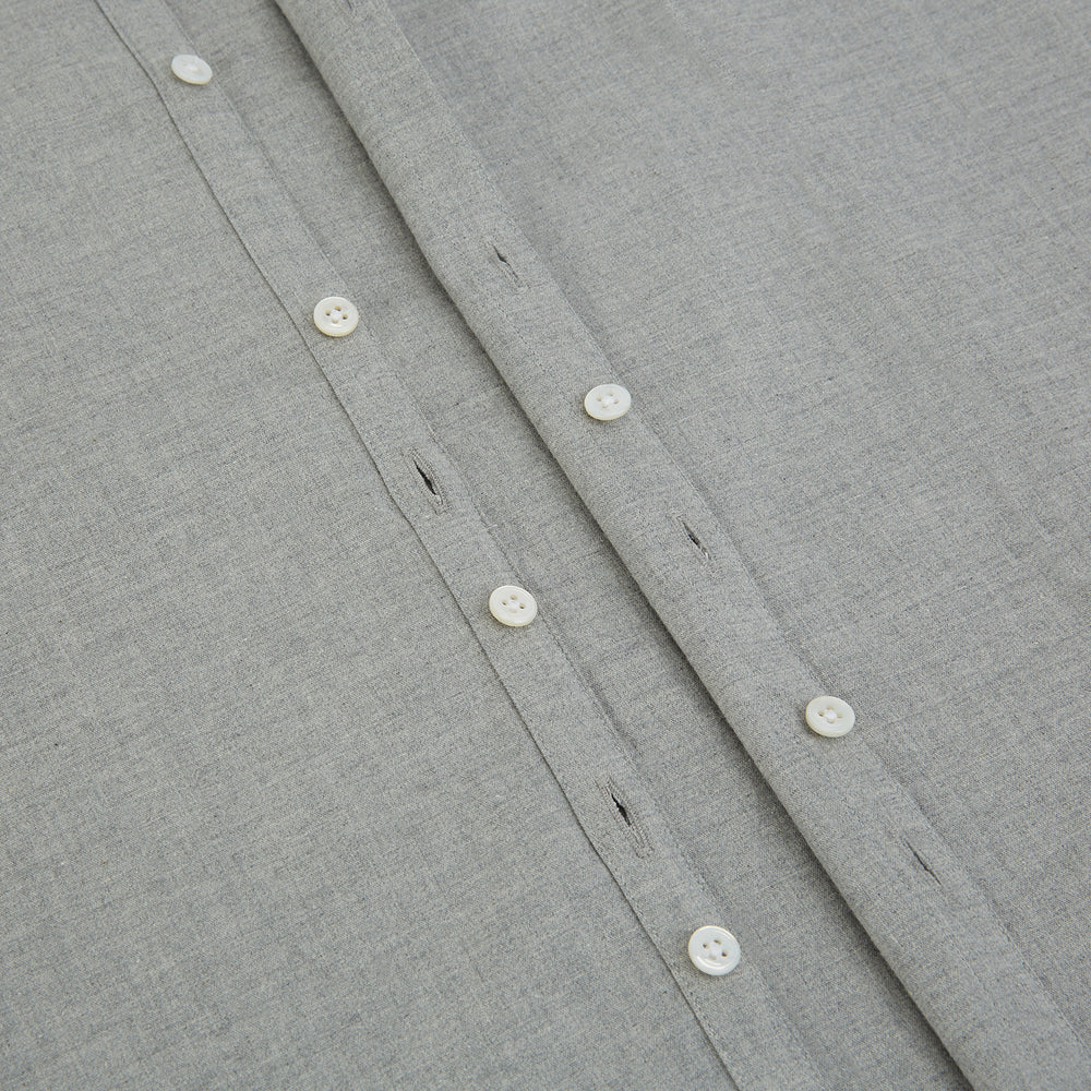 The Grey Westminster Shirt by Turnbull & Asser features a classic collar and white buttons, expertly crafted in Britain. This long-sleeve button-up is shown against a plain white background.