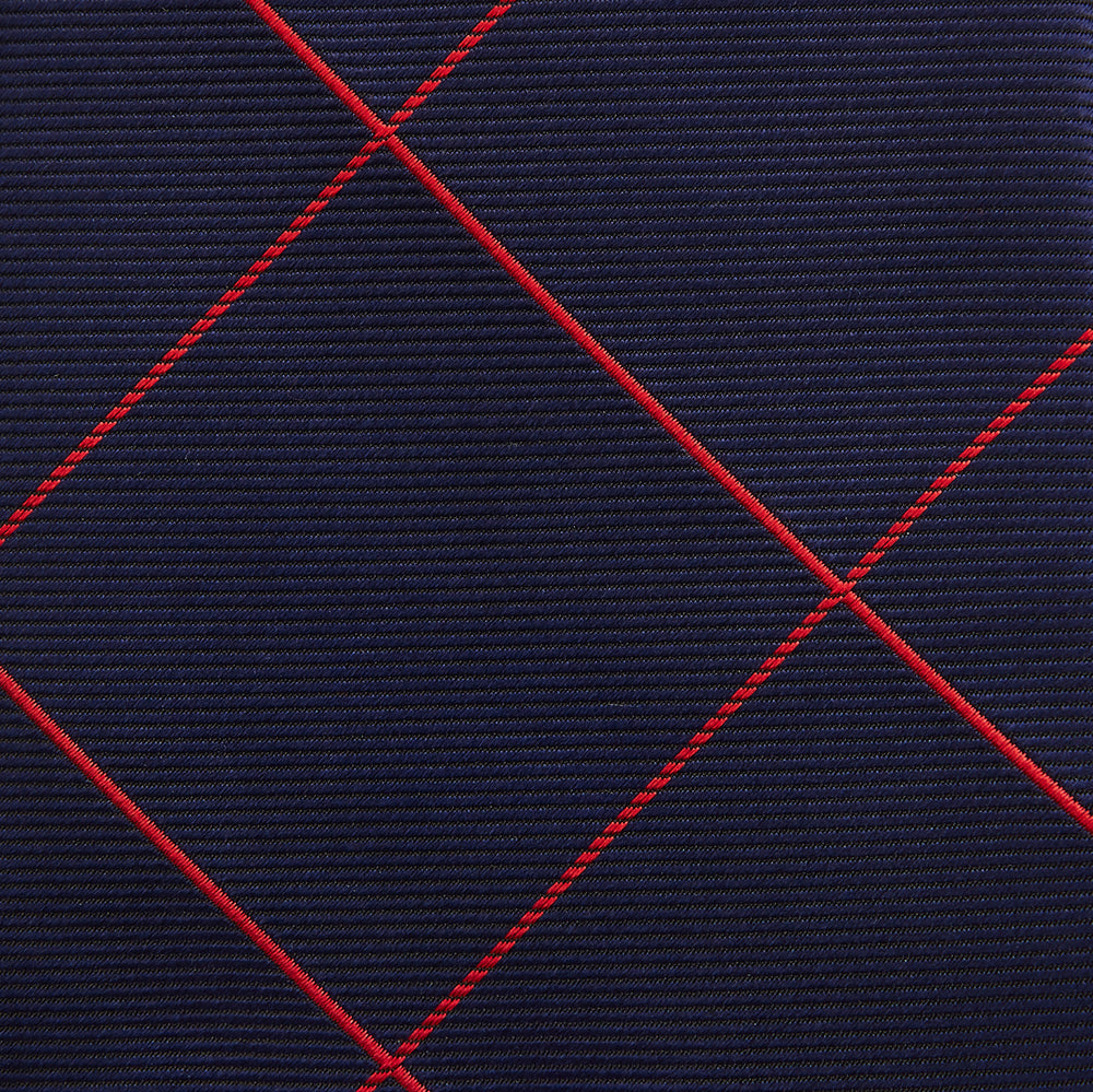 The Turnbull & Asser Red and Navy Window Pane Silk Tie features a refined diagonal red pattern on navy silk, making it an elegant choice for office attire.