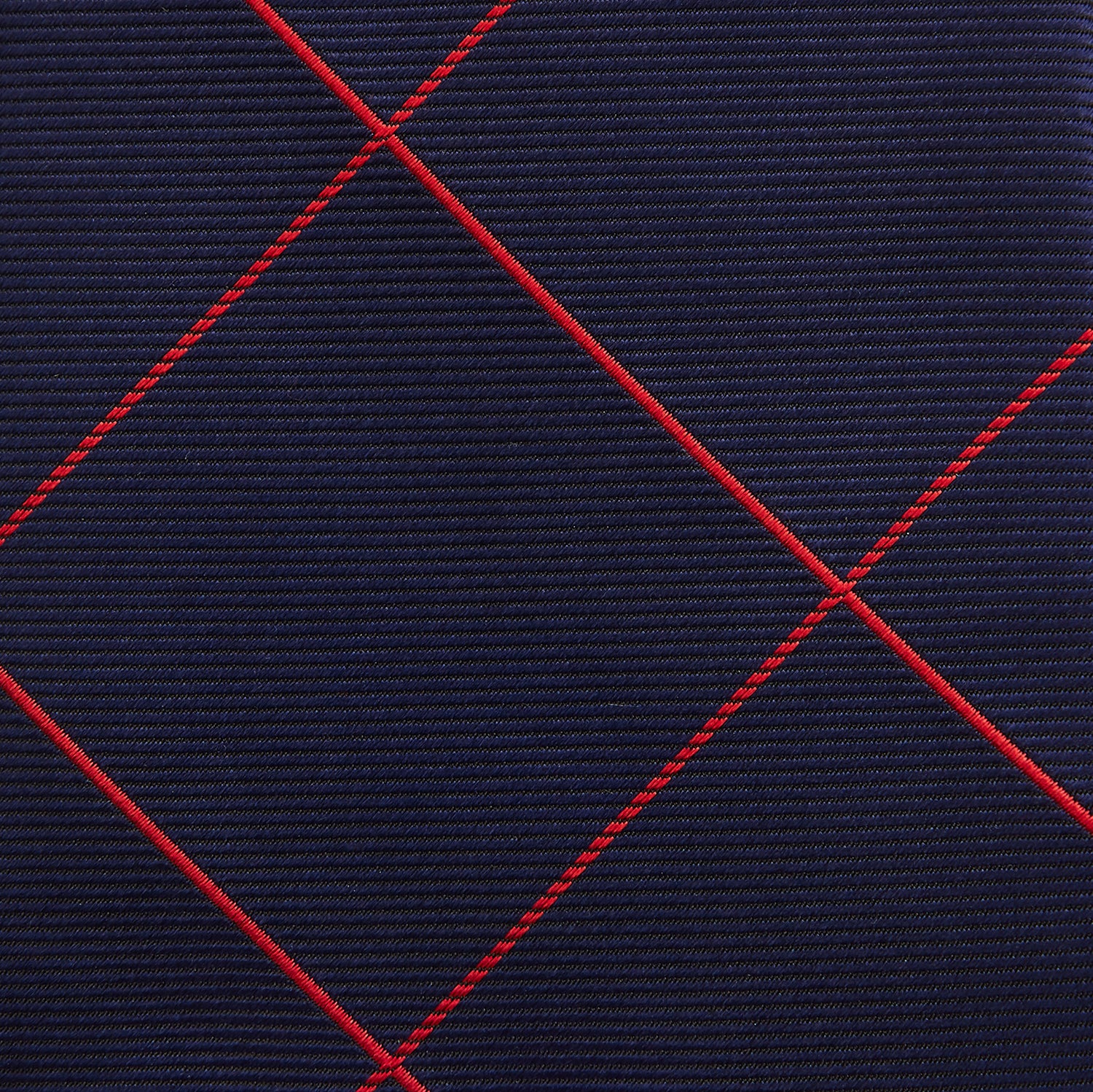 View 3 of product The Turnbull & Asser Red and Navy Window Pane Silk Tie features a refined diagonal red pattern on navy silk, making it an elegant choice for office attire.