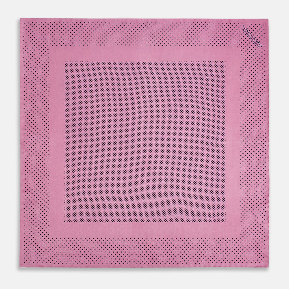 The Pink Dot Silk Pocket Square by Turnbull & Asser features pink silk with a border of small black dots, expertly handcrafted for a stylish touch to any suit. Fold to showcase both sides for added elegance.