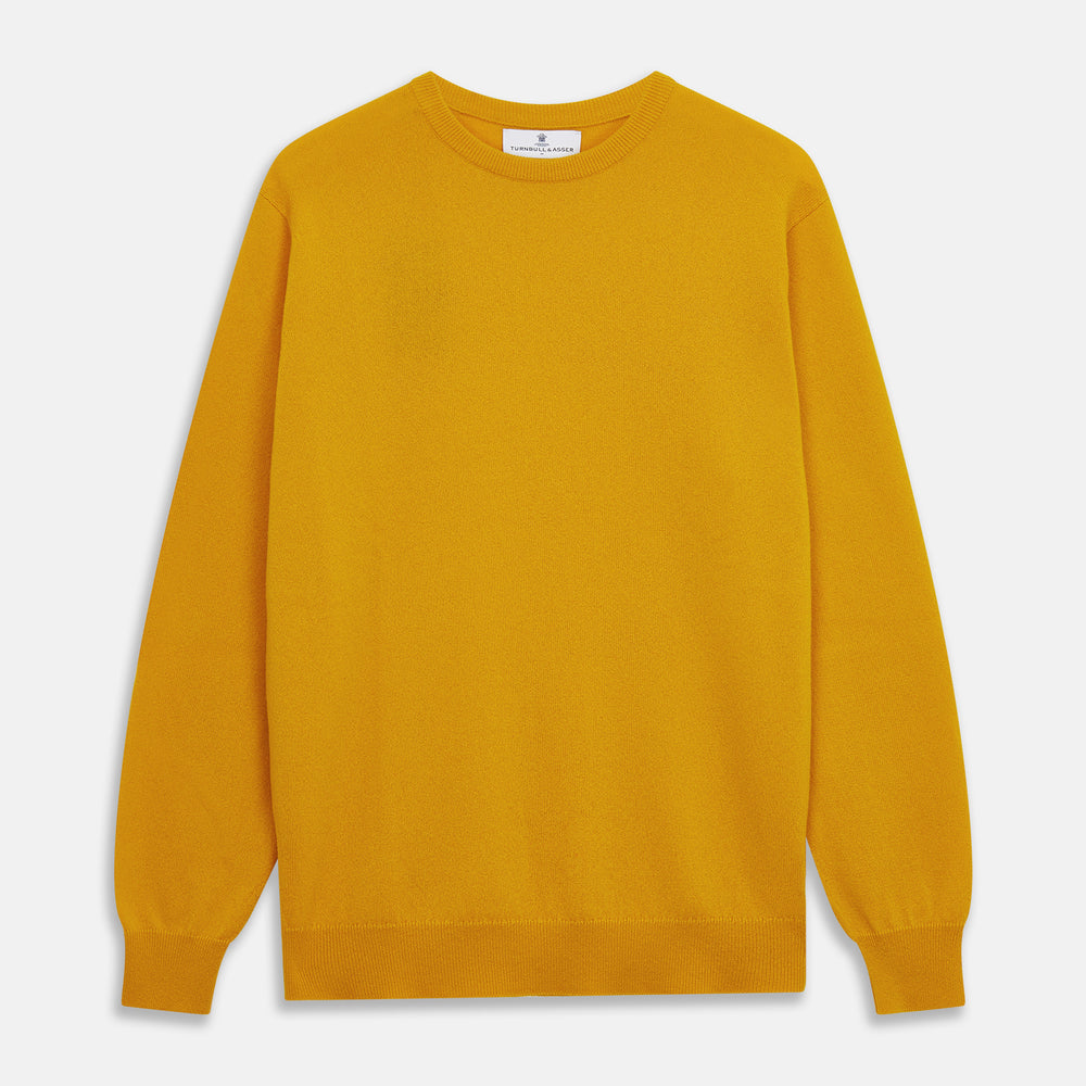 The Gold Glenn Cashmere Crew Neck Jumper by Turnbull & Asser is a luxurious, long-sleeved knit in vibrant mustard yellow, shown laid flat on a white background—an eye-catching essential.