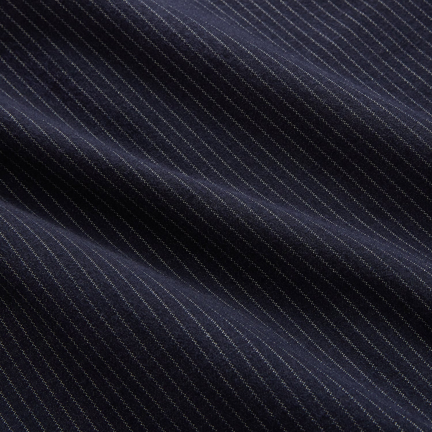 View 6 of product The Turnbull & Asser Navy Stripe Hampstead Overshirt features pinstripes, a collar, long sleeves, chest pocket, and two angled side pockets—ideal for refining your formal look. Shown laid flat on a light background.