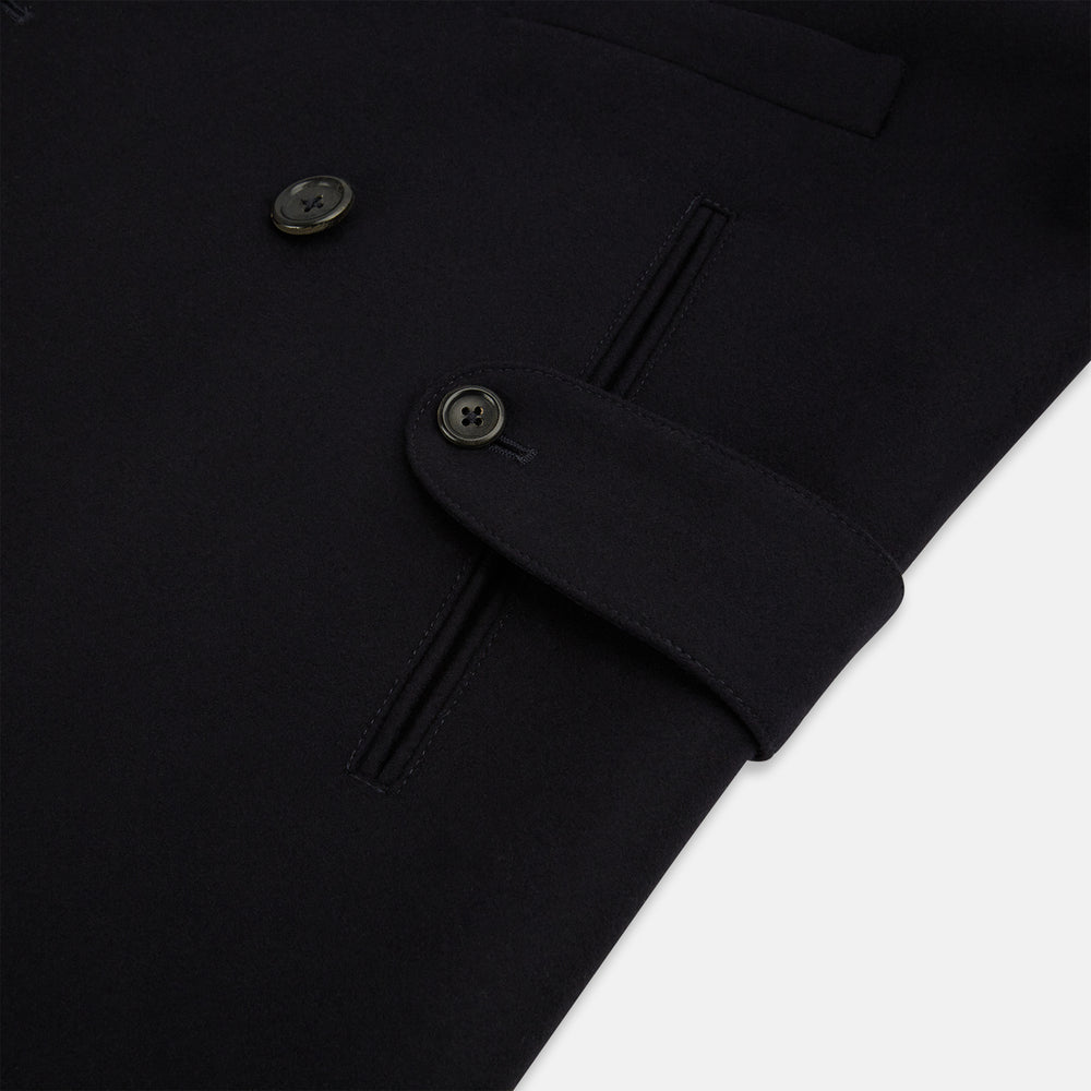 The Turnbull & Asser Navy Wellington Double-Breasted Caban Coat features wide lapels, six front buttons, a chest pocket, and two side pockets with buttoned flaps—ideal for polished formal wear.