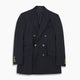 The Classic Navy Wool Blazer by Turnbull & Asser is a nautical double-breasted jacket with gold buttons, peaked lapels, three front pockets on one side, one on the other, and four gold buttons per cuff, shown against a white background.