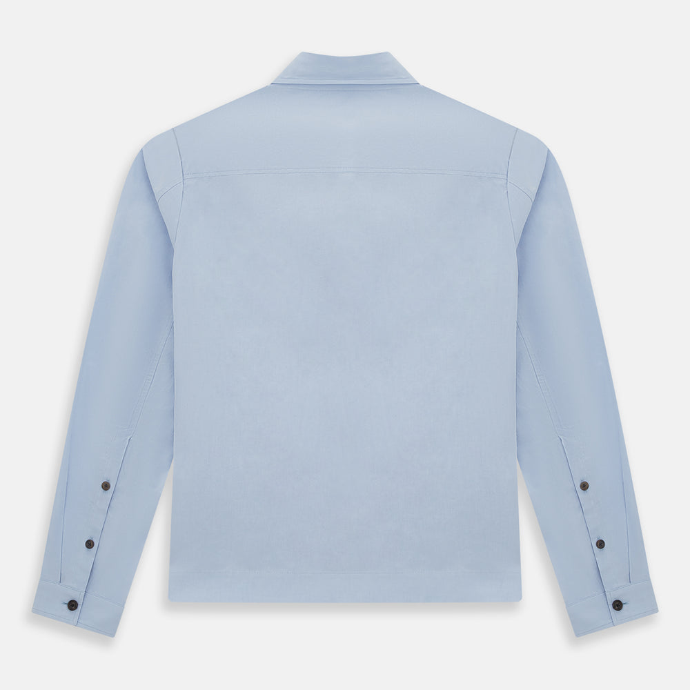 The Turnbull & Asser Pale Blue Hyde Overshirt is a long-sleeve, sanforised cotton button-up with a single chest pocket and dark buttons, shown on a plain white background.