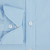 View 4 of product The Turnbull & Asser Dr. No Blue Cotton Shirt with cocktail cuffs, inspired by James Bond, features a classic collar and white buttons, displayed on a plain white background.