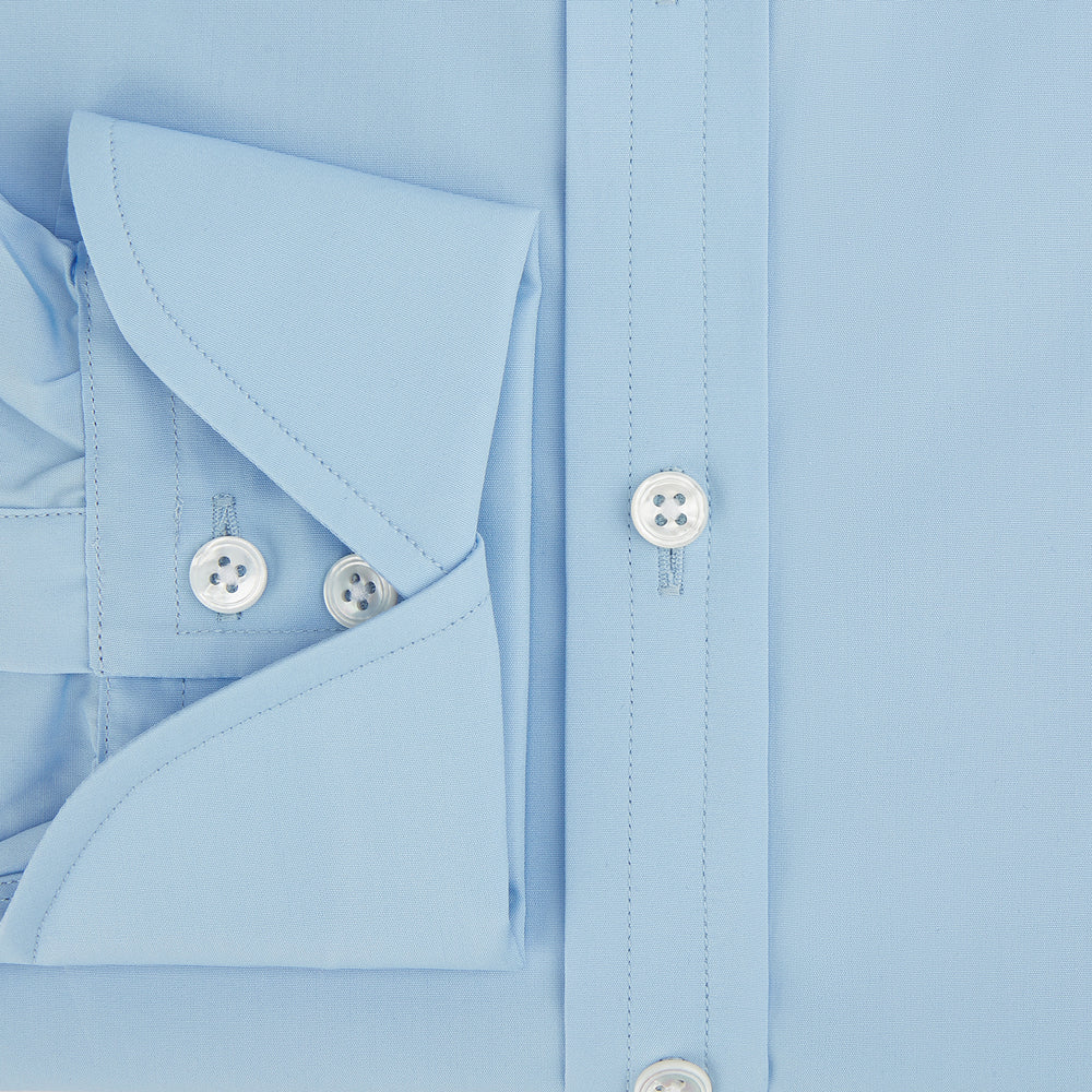 The Turnbull & Asser Dr. No Blue Cotton Shirt with cocktail cuffs, inspired by James Bond, features a classic collar and white buttons, displayed on a plain white background.