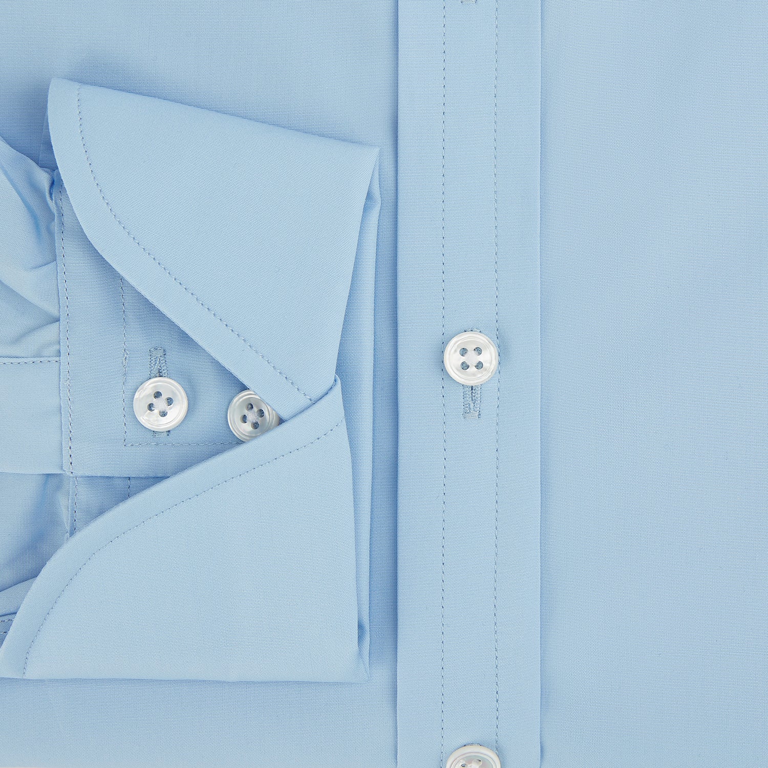 View 4 of product The Turnbull & Asser Dr. No Blue Cotton Shirt with cocktail cuffs, inspired by James Bond, features a classic collar and white buttons, displayed on a plain white background.
