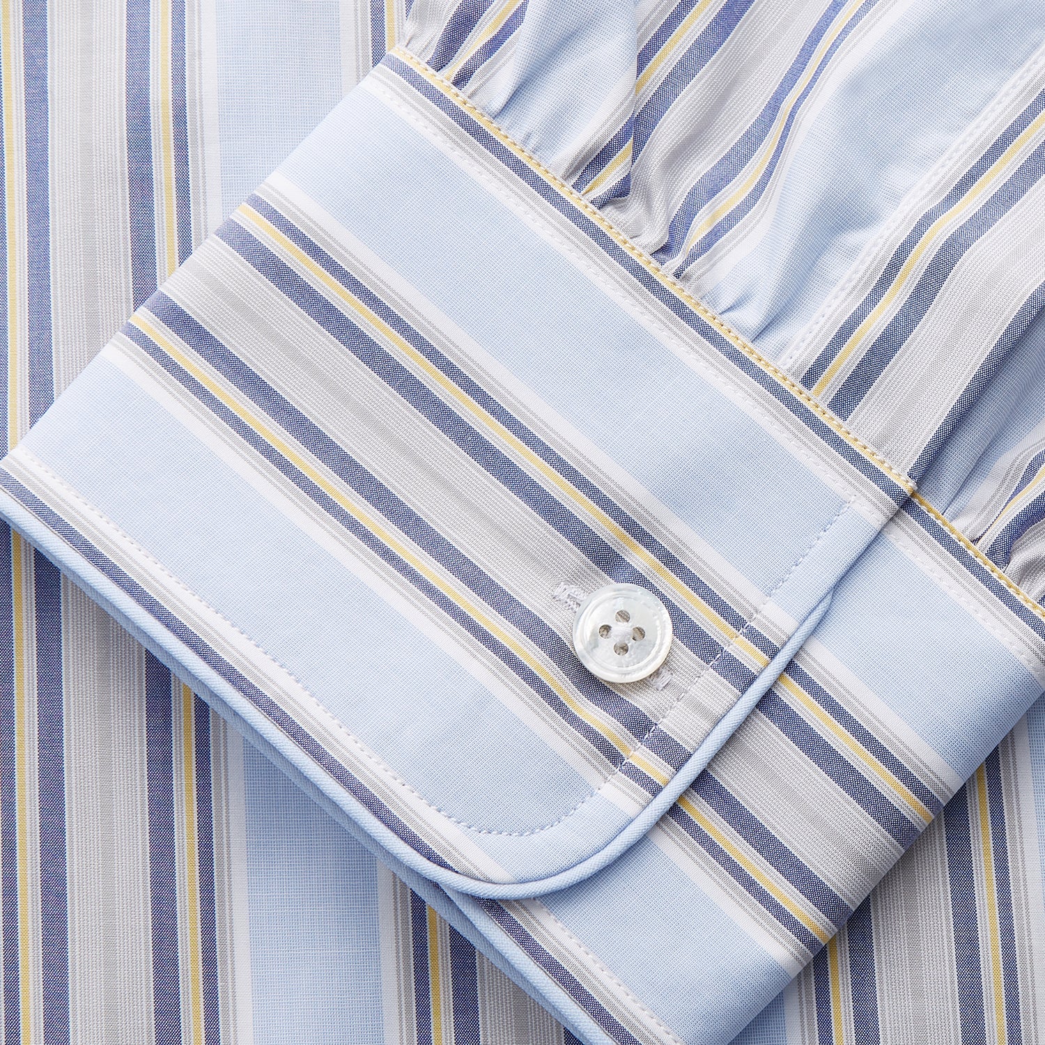 View 3 of product The Pale Blue and Yellow Multi Stripe Cotton Sussex Nightshirt by Turnbull & Asser features long sleeves, a knee-length cut, a collar, button-down front, chest pocket, and rounded hem.