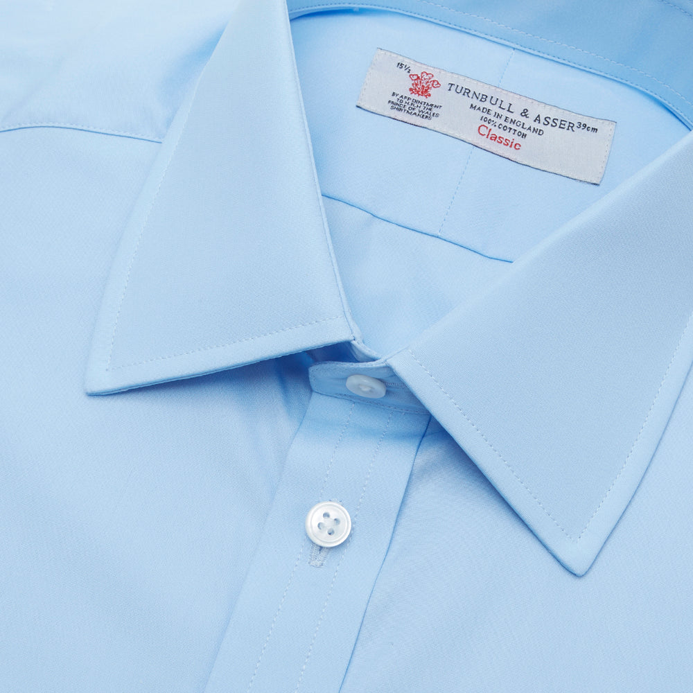 A Light Blue Cotton Shirt with a T&A collar and 3-button cuffs by Turnbull & Asser is displayed on a plain white background, ideal for pairing with a navy suit.