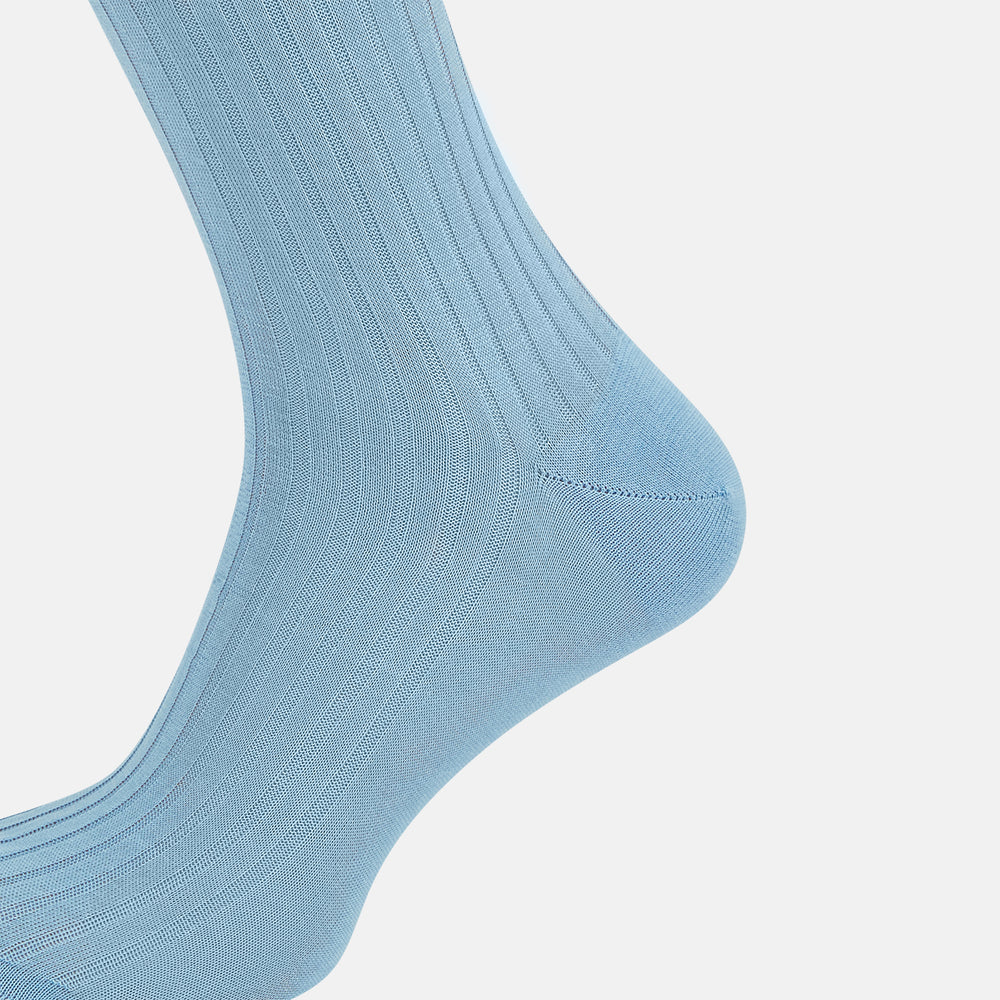 A single Turnbull & Asser Pale Blue Mid-Length Sock, made from Egyptian cotton with a ribbed texture, is displayed upright against a plain white background.
