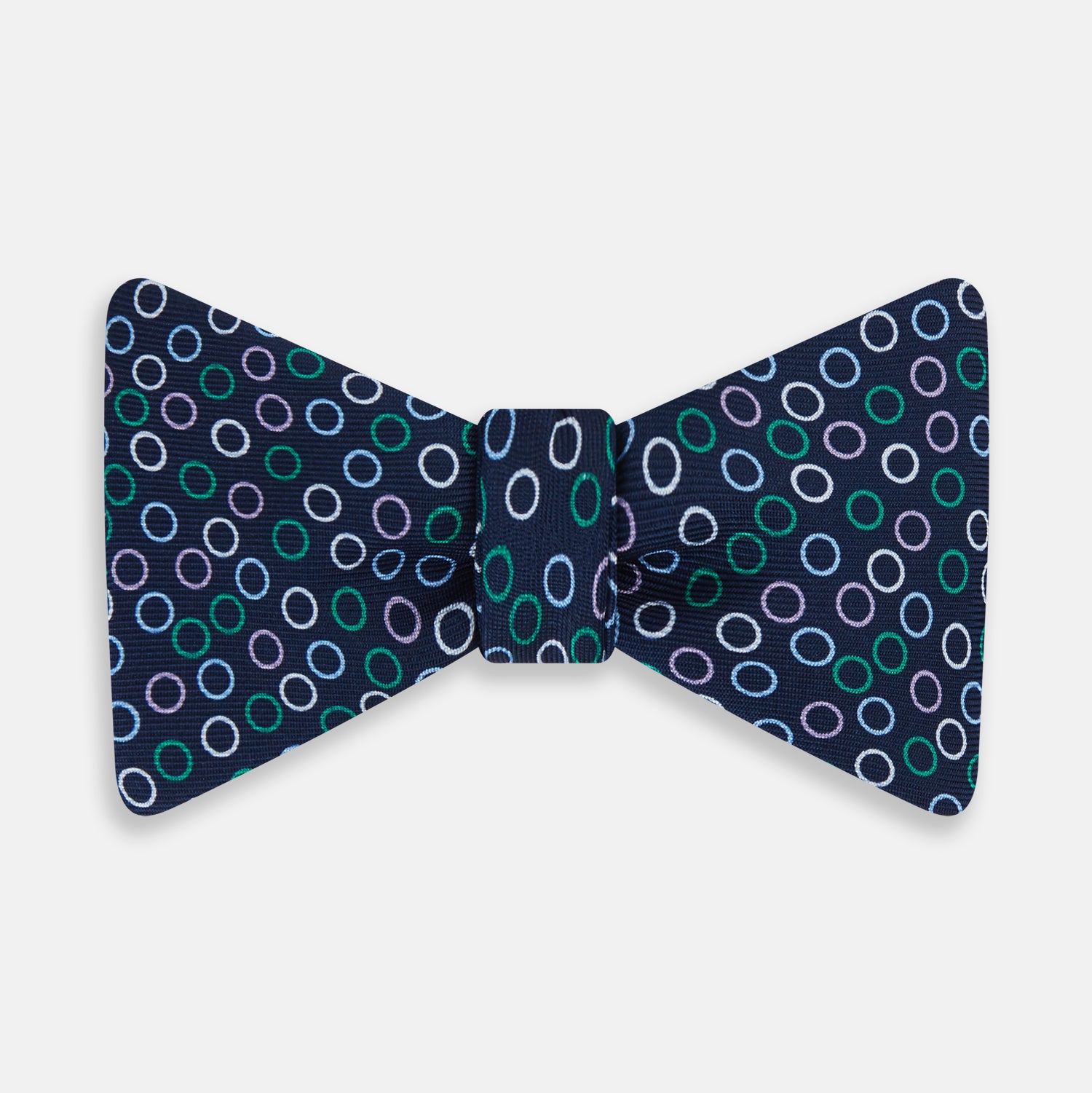 View 1 of product The Turnbull & Asser Multicoloured Dark Navy Circle Silk Bow Tie showcases evenly spaced blue, green, and white ovals—a sophisticated men's accessory perfect for any occasion.