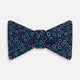 The Turnbull & Asser Multicoloured Dark Navy Circle Silk Bow Tie showcases evenly spaced blue, green, and white ovals—a sophisticated men's accessory perfect for any occasion.