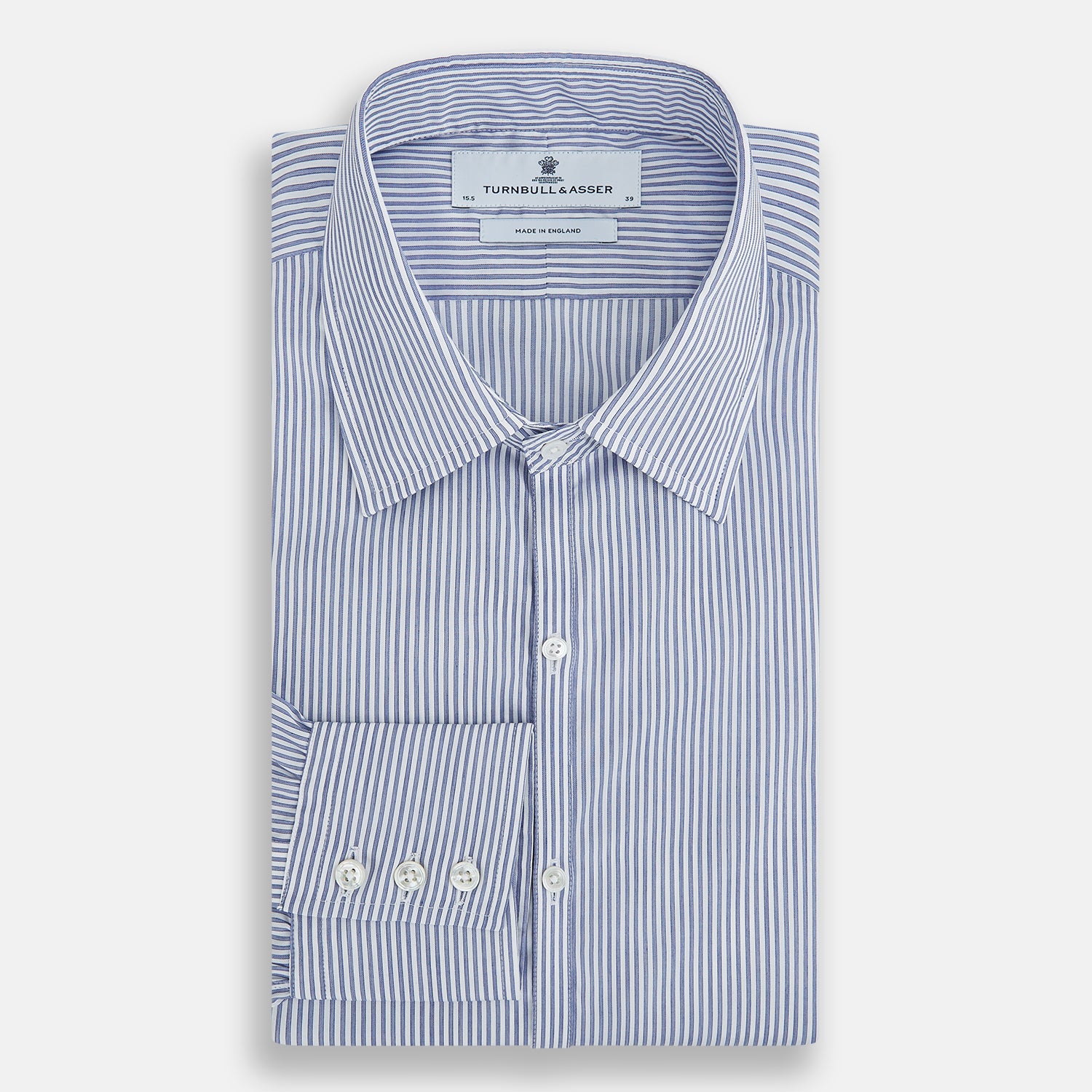 View 7 of product The Turnbull & Asser Navy and White Stripe Westminster Shirt features thin vertical stripes, a Turnbull collar, long sleeves, and classic British craftsmanship, shown flat on a white background.