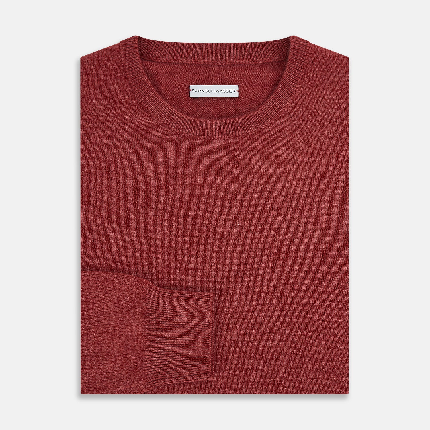 View 4 of product The Turnbull & Asser Crimson Red Cashmere Round Neck Jumper is a classic men’s knitwear piece, featuring long sleeves and a solid crimson hue, shown against a white background.