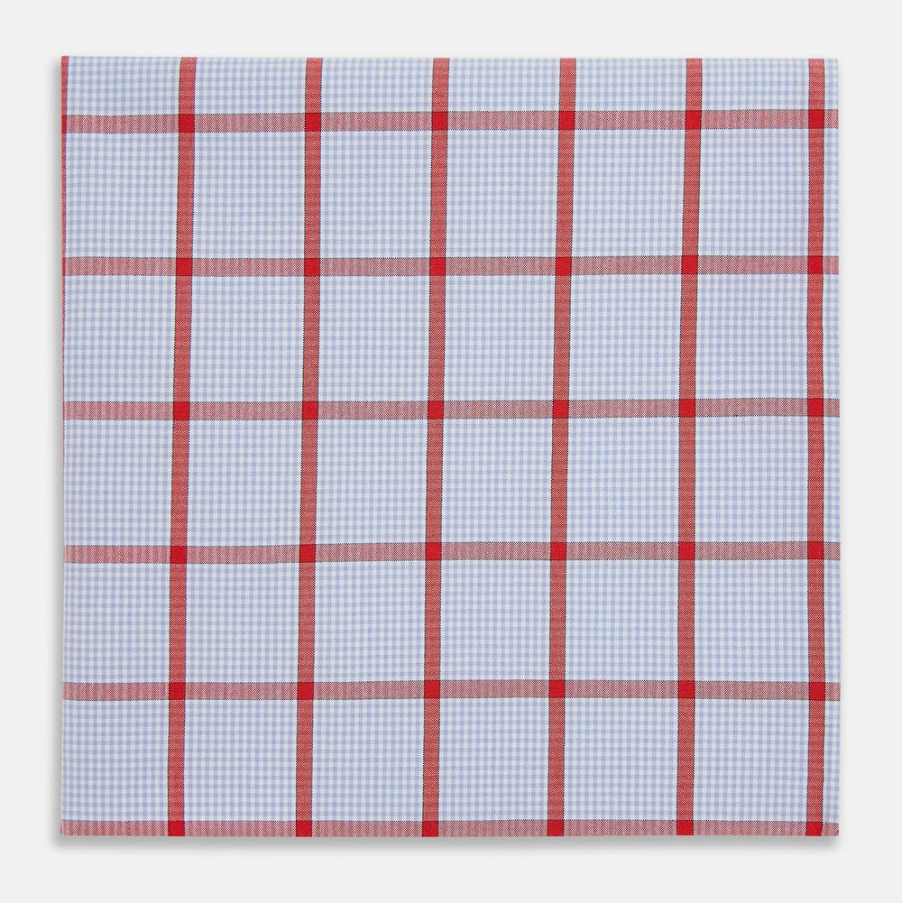 The Turnbull & Asser Hand Rolled Red Windowpane Check Handkerchief features a light blue and white gingham base with red checks—perfect as a gentleman's pocket square for a refined, classic touch.