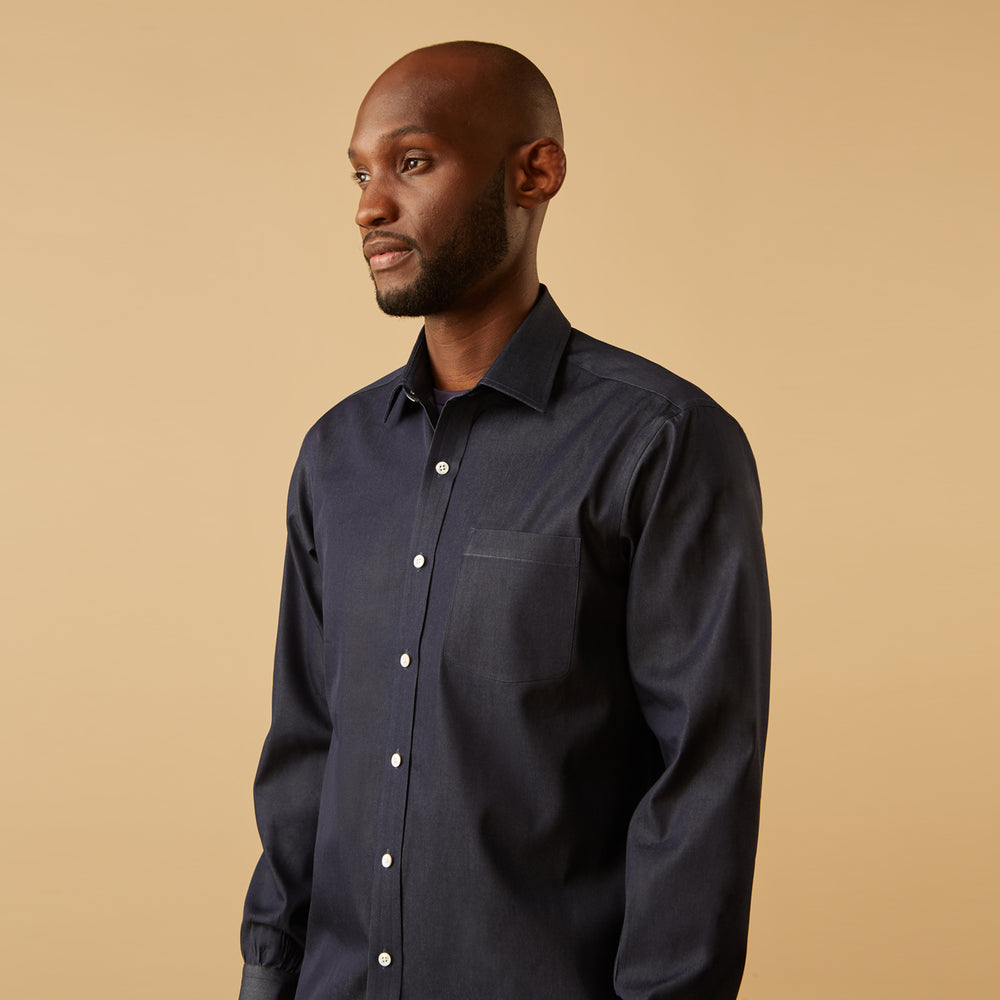 The Turnbull & Asser Blue Weekend Fit Finch Shirt features a Derby collar, chest pocket, classic white buttons, and timeless style, all in cotton. Laid flat on a white background.