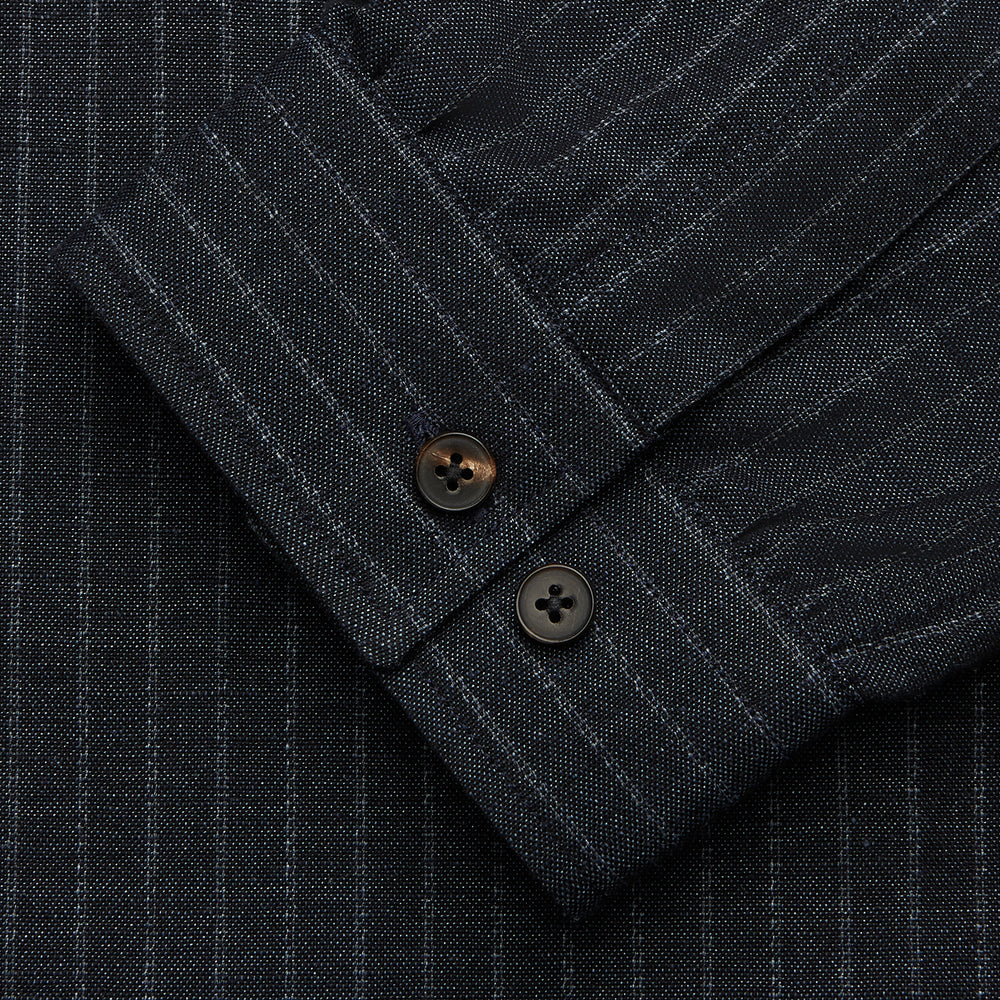 The Navy Tailored Pinstriped Shirt Jacket by Turnbull & Asser is a smart-casual, lightweight cotton-linen piece with long sleeves, a collar, left chest pocket, and front buttons for easy style.