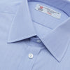 View 5 of product The Turnbull & Asser Blue Hairline Stripe Shirt features a T&A collar, 3-button cuffs, and white buttons. Made from light blue cotton with subtle stripes, it’s neatly folded with the label visible inside the collar on a plain white background.