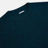 View 2 of product The Turnbull & Asser Dark Green Melange Cashmere Round Neck Jumper features long sleeves with ribbed cuffs and a ribbed hem, shown against a plain white background.
