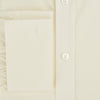 View 4 of product The Turnbull & Asser Cream Cotton Shirt features a T&A collar and double cuffs, elevating men's style. Displayed flat against a white background, this long-sleeve shirt is crafted in classic cream cotton.