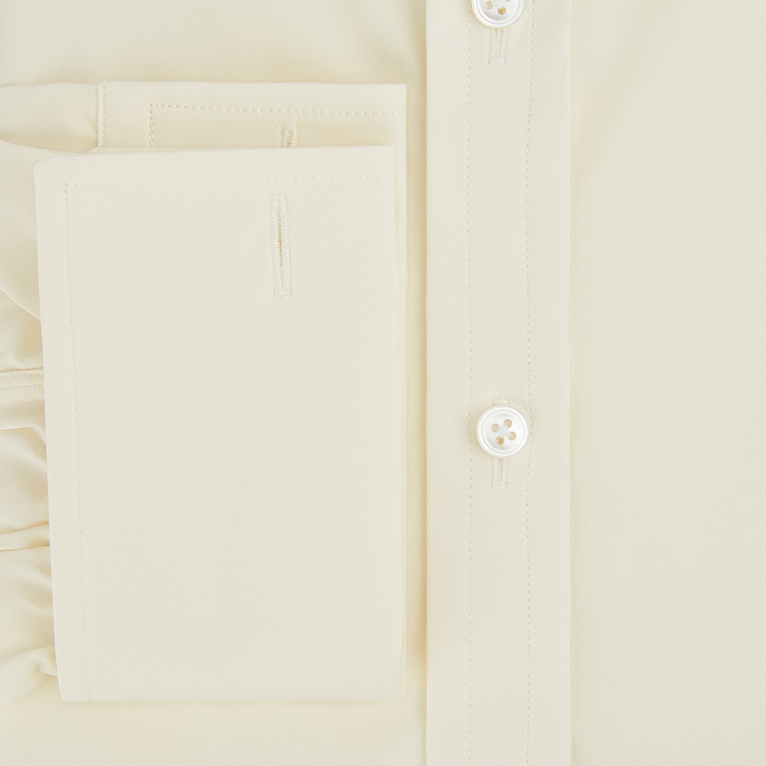 View 4 of product The Turnbull & Asser Cream Cotton Shirt features a T&A collar and double cuffs, elevating men's style. Displayed flat against a white background, this long-sleeve shirt is crafted in classic cream cotton.