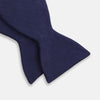 View 3 of product The Turnbull & Asser HERRINGBONE NAVY BOW TIE features a subtle herringbone pattern in navy blue, shown against a plain white background—the perfect accessory to elevate any smart look.