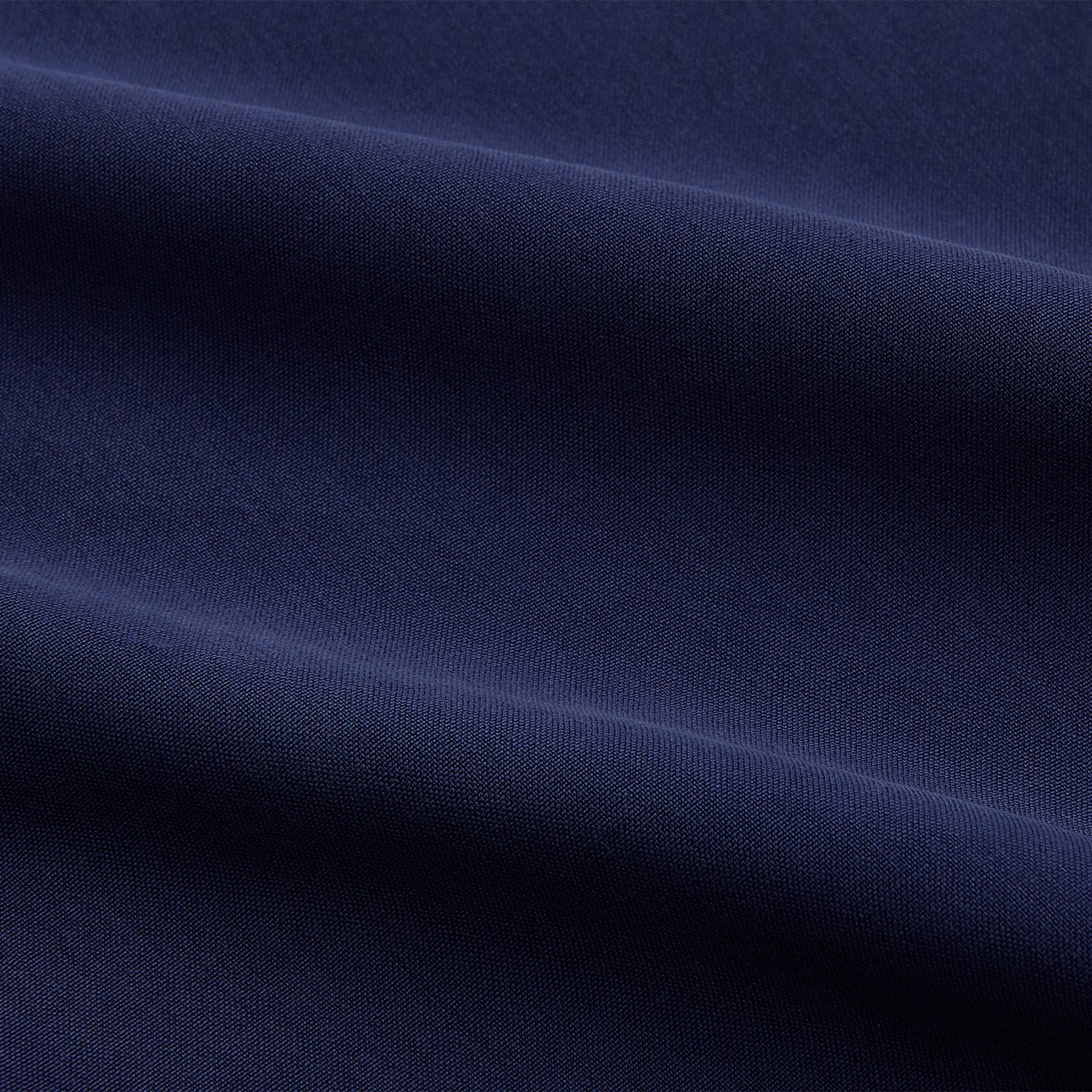View 11 of product The Turnbull & Asser Blue Soft-touch Silk Lauren Shirt is a navy, long-sleeve button-up with an Igret stand collar, white buttons, curved hem, relaxed fit, and elongated body for a modern look, shown laid flat on a white background.