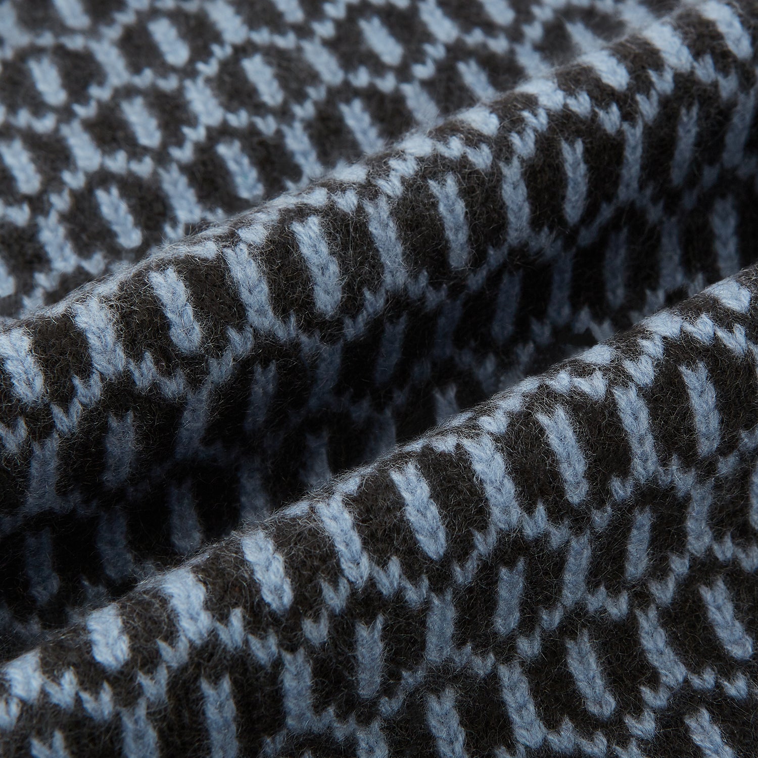 View 3 of product The Turnbull & Asser Dark Chocolate and Pale Blue Hexagon Cashmere Knitted Scarf is elegantly looped against a white background—an essential geometric accessory for any wardrobe.