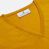 View 2 of product The Gold Ifor Cashmere Slipover by Turnbull & Asser is a sleeveless, V-neck knit in bright mustard yellow, made in Scotland and shown laid flat against a white background.