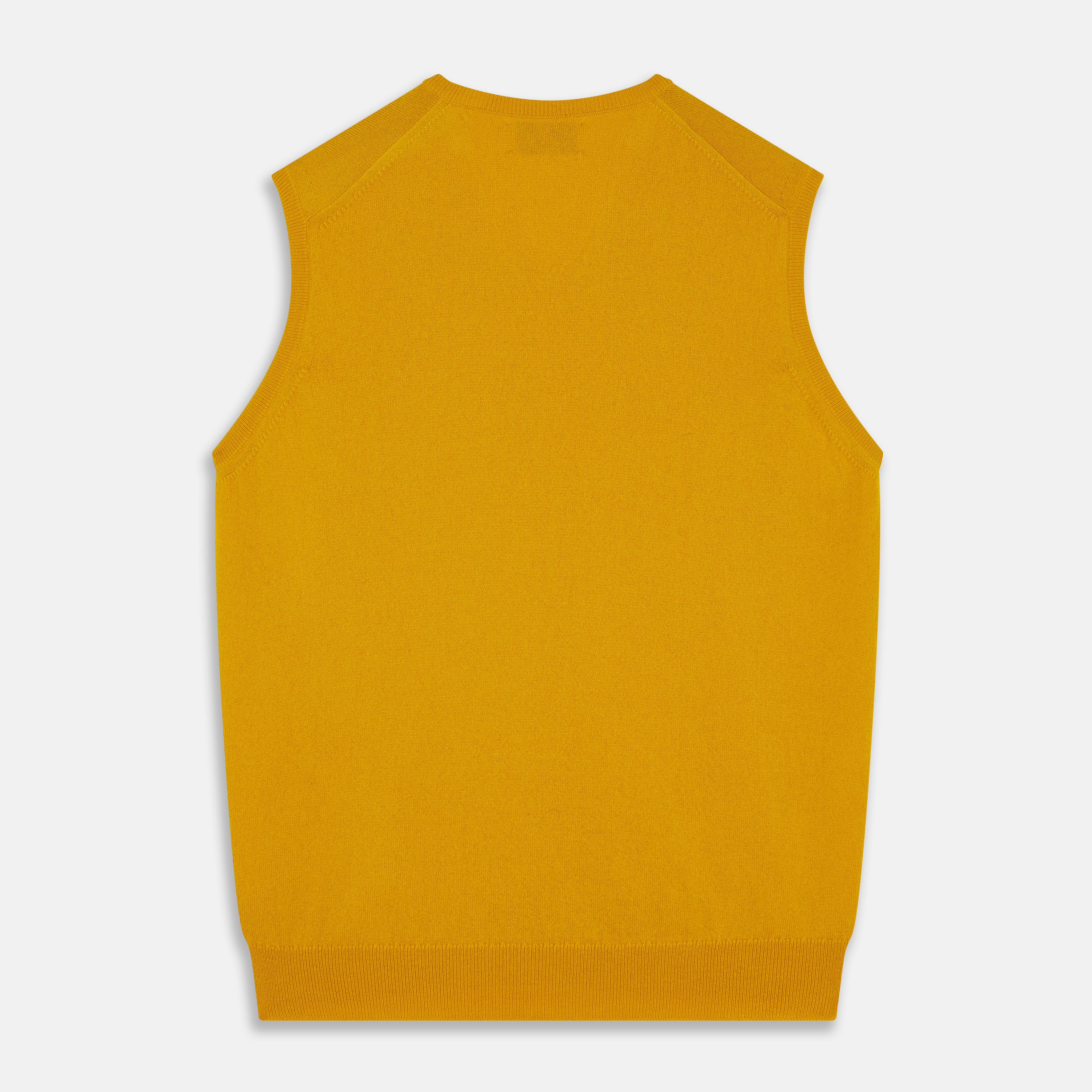 View 3 of product The Gold Ifor Cashmere Slipover by Turnbull & Asser is a sleeveless, V-neck knit in bright mustard yellow, made in Scotland and shown laid flat against a white background.