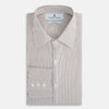 View 5 of product The Turnbull & Asser Coffee Multi Stripe Westminster Shirt features long sleeves, a button-up front, subtle beige and white stripes, a pointed Turnbull collar, and buttoned cuffs—expertly crafted in Britain and shown flat on a white background.