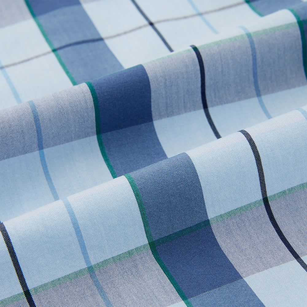 The Turnbull & Asser Blue Multi Check Pyjama Shirt features a blue and white check pattern, long sleeves, and a collar—an elegant loungewear option perfect for nightwear.