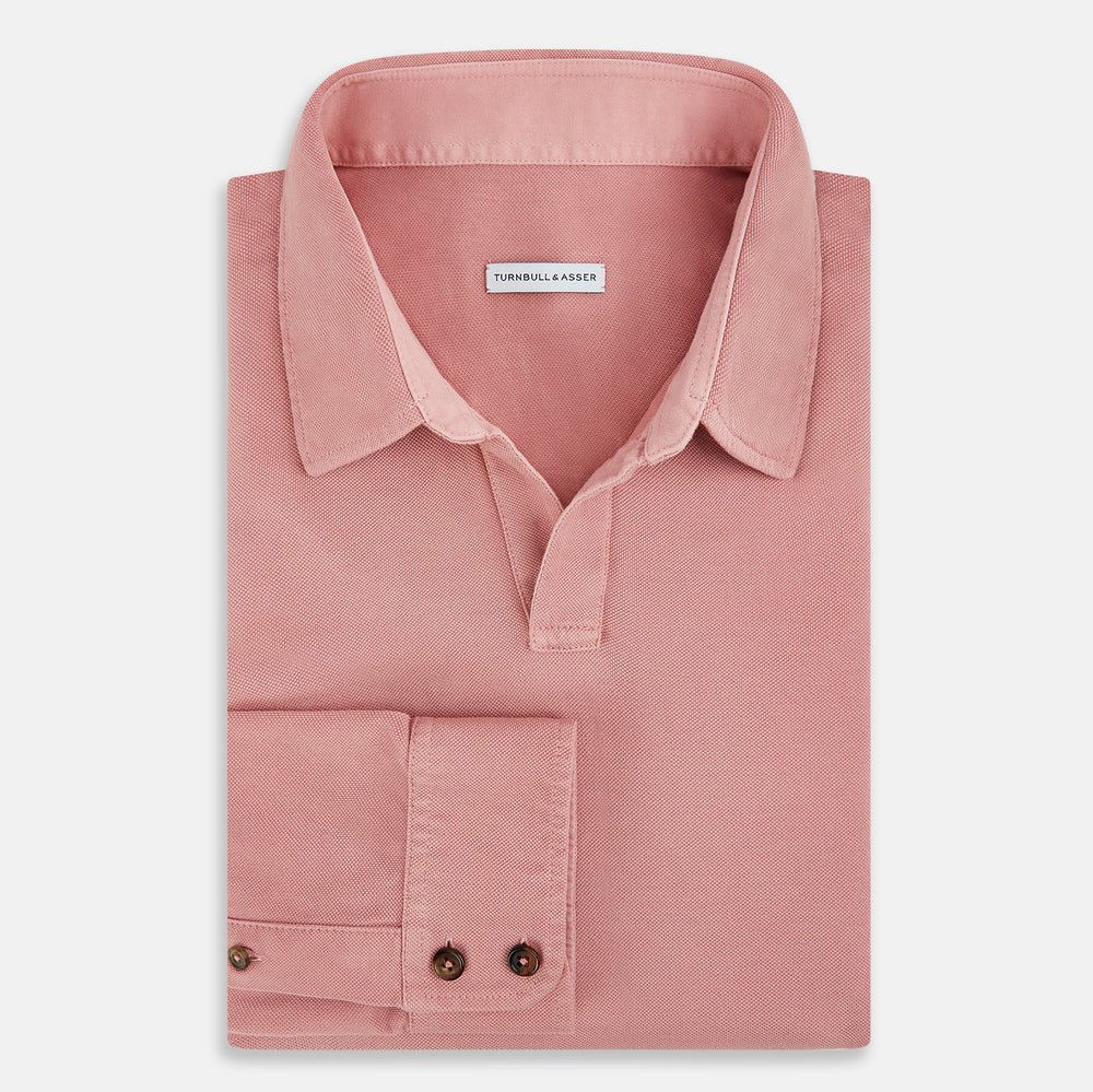 A Turnbull & Asser Red Rugby Polo Shirt with long sleeves, a collared neckline, v-neck opening, and no buttons is laid flat on a white background.