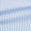 View 6 of product The Turnbull & Asser Blue Bengal Stripe Mayfair Shirt features light blue and white vertical stripes, a classic T&A collar, white buttons, and buttoned cuffs. Laid flat on a white background.