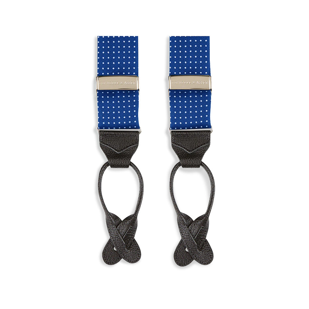 Turnbull & Asser Royal Blue Small Spot Adjustable Silk Braces, detailed with black leather ends and silver clips, are perfect for refined style. Shown laid flat on a plain white background.