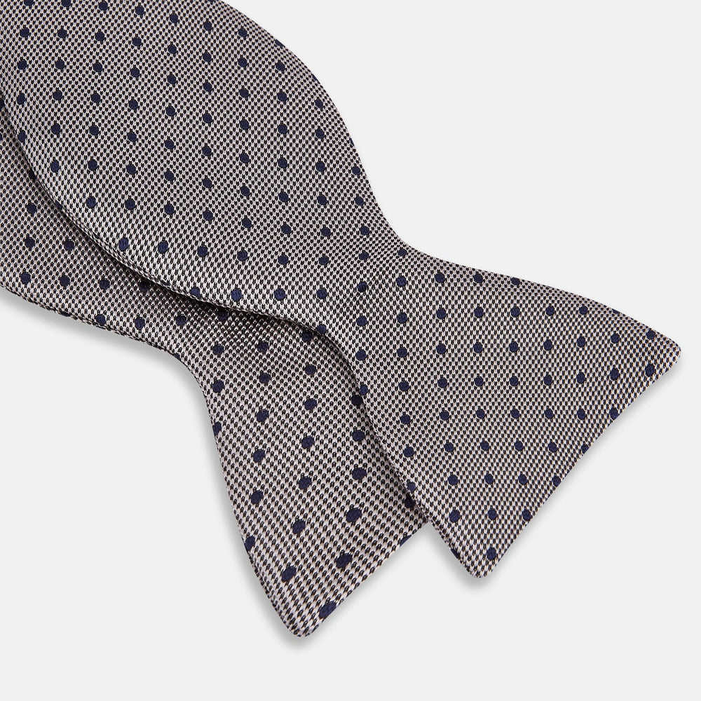 The Turnbull & Asser Navy and Silver Micro Dot Silk Bow Tie, featuring a refined dot pattern, is displayed on a white background.