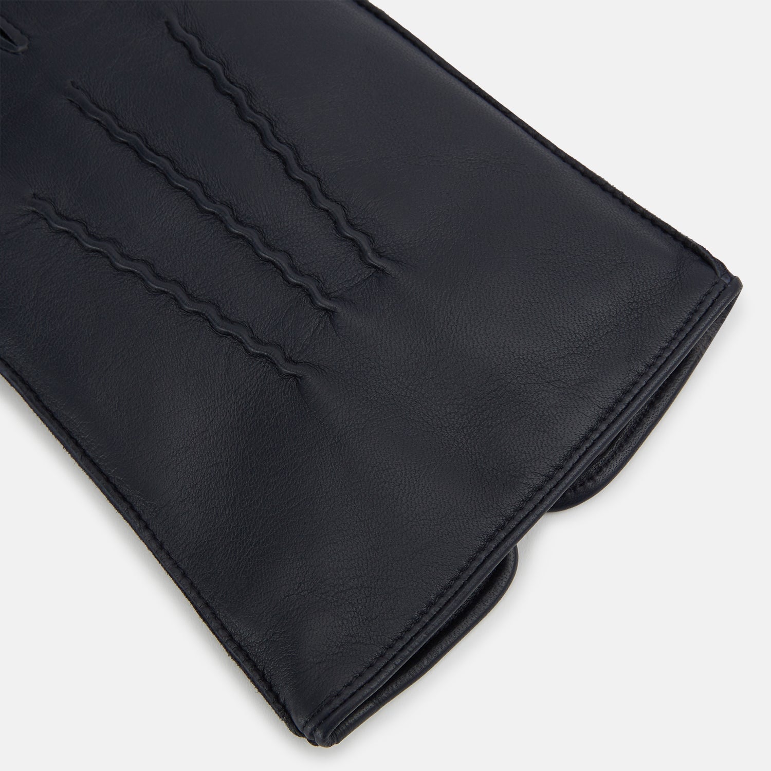 View 2 of product A pair of Turnbull & Asser Navy/Grey Fur-Lined Hairsheep Leather Touchscreen Gloves is displayed on a light background, with one glove showing the palm and the other the back, both featuring simple stitched details and a wrist button closure.