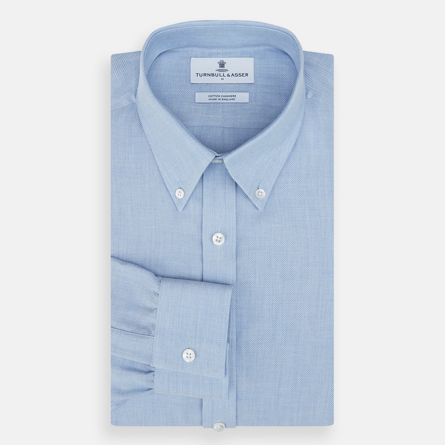 View 4 of product The Turnbull & Asser Pale Blue Cotton Cashmere Dorset Collar Richmond Shirt features long sleeves, a button-down collar, white buttons, and a chest pocket. It is neatly displayed flat on a white background.