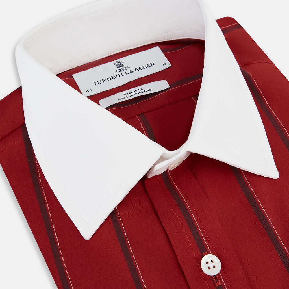 The Turnbull & Asser Dark Red Track Stripe Shirt with Contrast T&A Collar and Cuffs features vertical black stripes, a white collar and cuffs, Mayfair fit, and fine British craftsmanship, shown laid flat on a plain background.