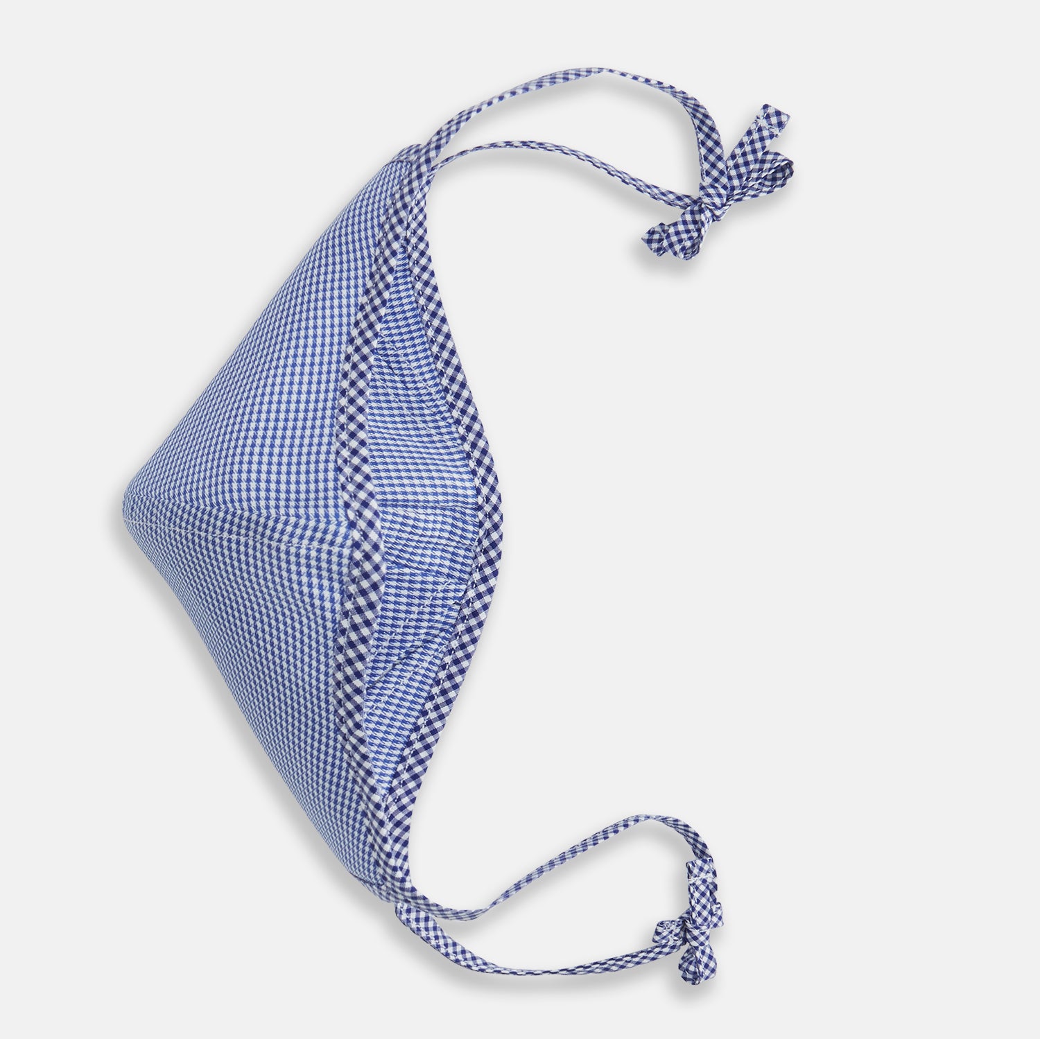 View 3 of product The Turnbull & Asser White & Navy Multi Check Commuter Mask comes with 3 Viroformula™ filters and two adjustable tie straps on each side, shown on a plain white background.