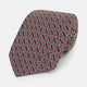 A close-up of the Turnbull & Asser Red and Navy Weave Patterned Silk Tie, showcasing its geometric design in red, blue, white, and yellow on a white background.