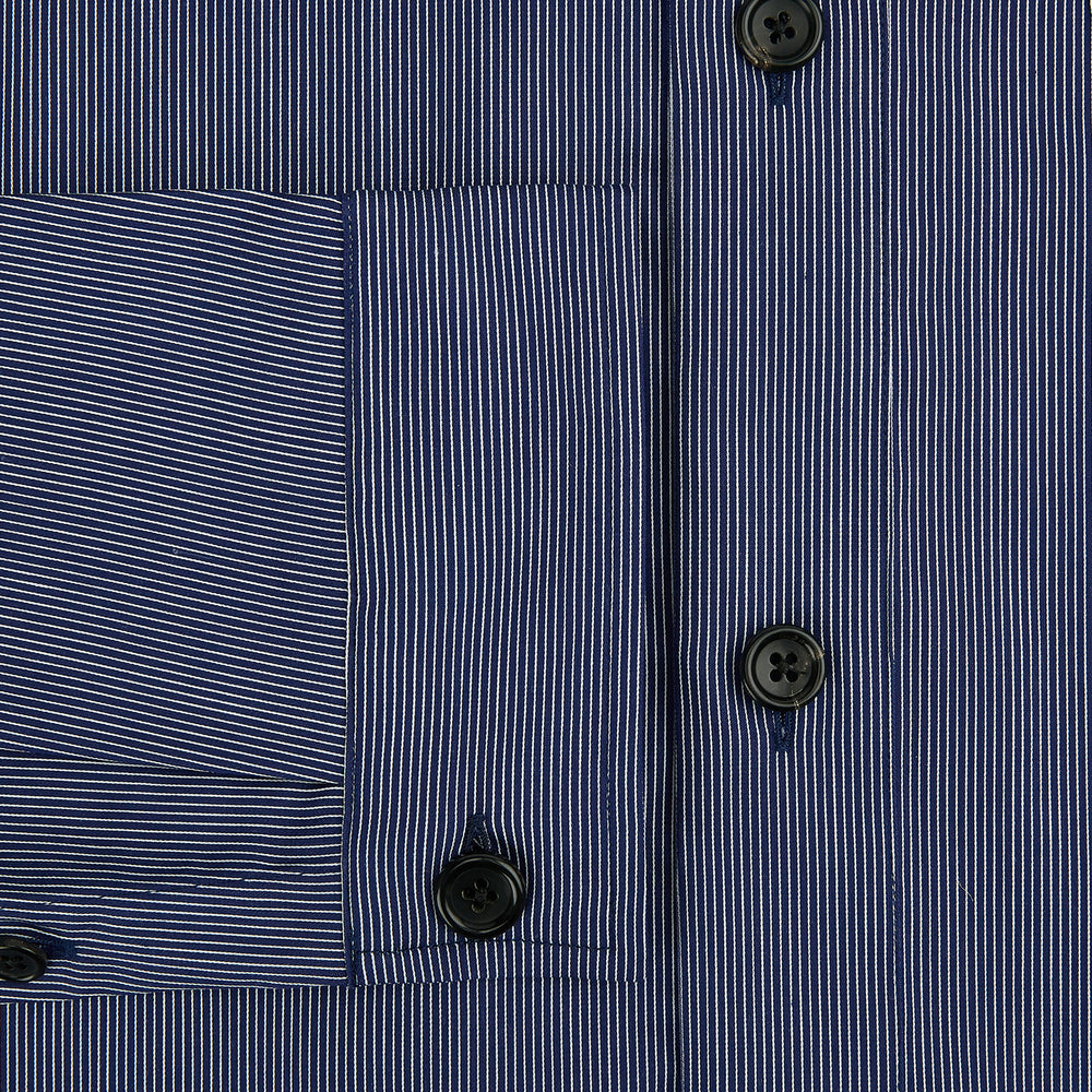 Turnbull & Asser’s Navy Stripe Highbury Overshirt with long sleeves, button-up front, black buttons, collar, and a left chest pocket is shown laid flat on a white background.