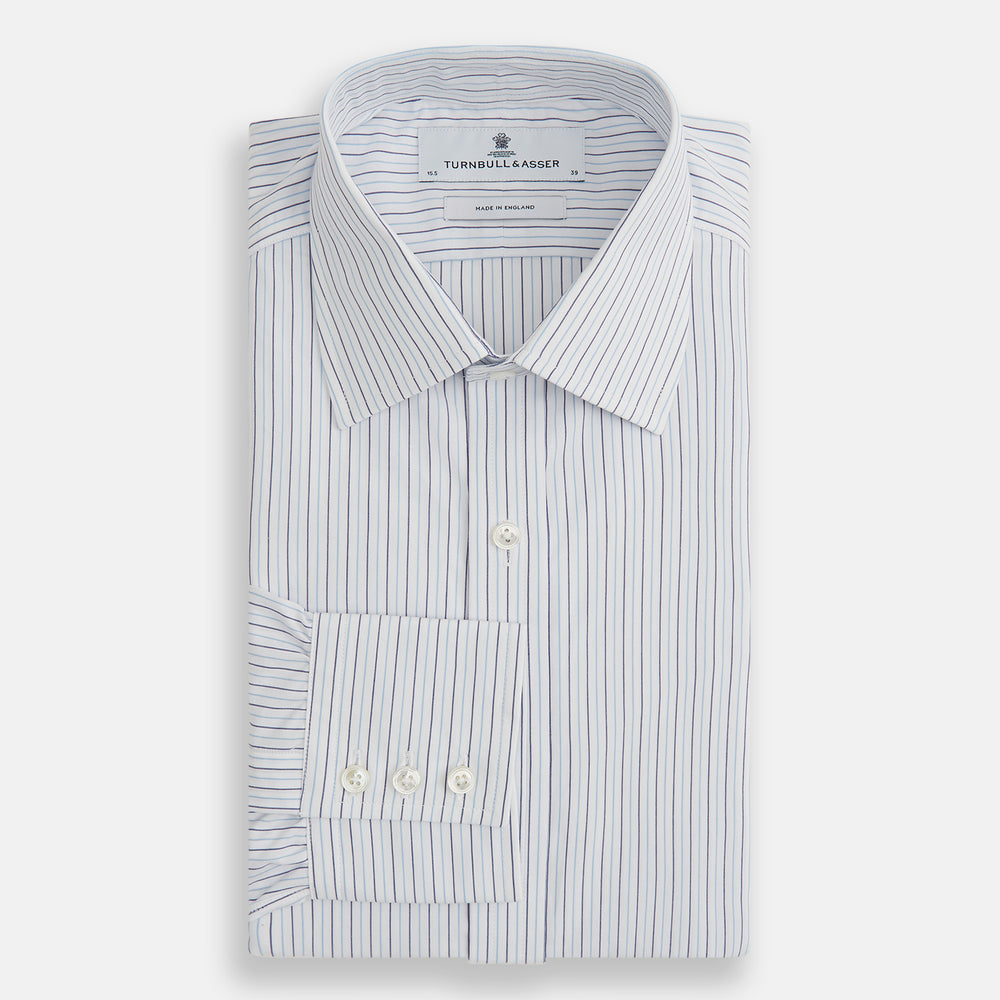 The Blue Double Pinstripe Mayfair Shirt by Turnbull & Asser is made from organic cotton with thin blue and white stripes, a pointed collar, and buttoned cuffs—perfect for elevating your workweek rotation.