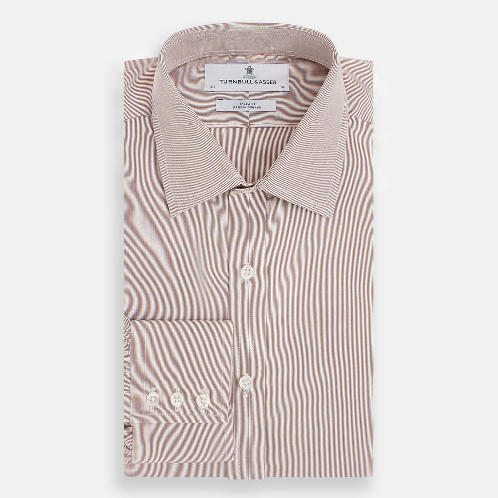 The Turnbull & Asser Burgundy Hairline Stripe Mayfair Shirt features long sleeves, a pointed collar, white buttons, and a classic Mayfair fit—perfect for formal occasions—presented against a plain white background.