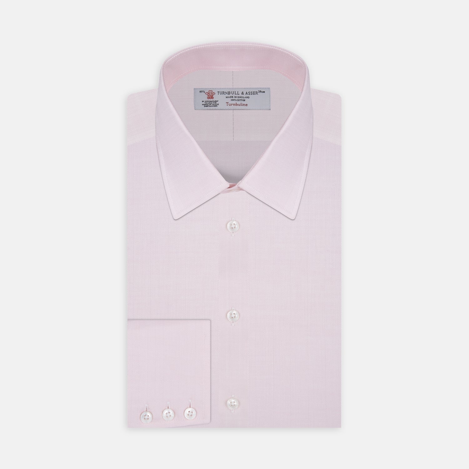 View 1 of product A Pink Herringbone Superfine Cotton Shirt by Turnbull & Asser, featuring a T&A collar and 3-button cuffs, is neatly folded with the inner collar label visible and white buttons, set against a plain white background.