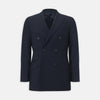 View 5 of product The Turnbull & Asser Navy Wool Pinstripe Double-Breasted Jacket features peak lapels, four front buttons, and three front pockets, and is displayed on a plain white background.