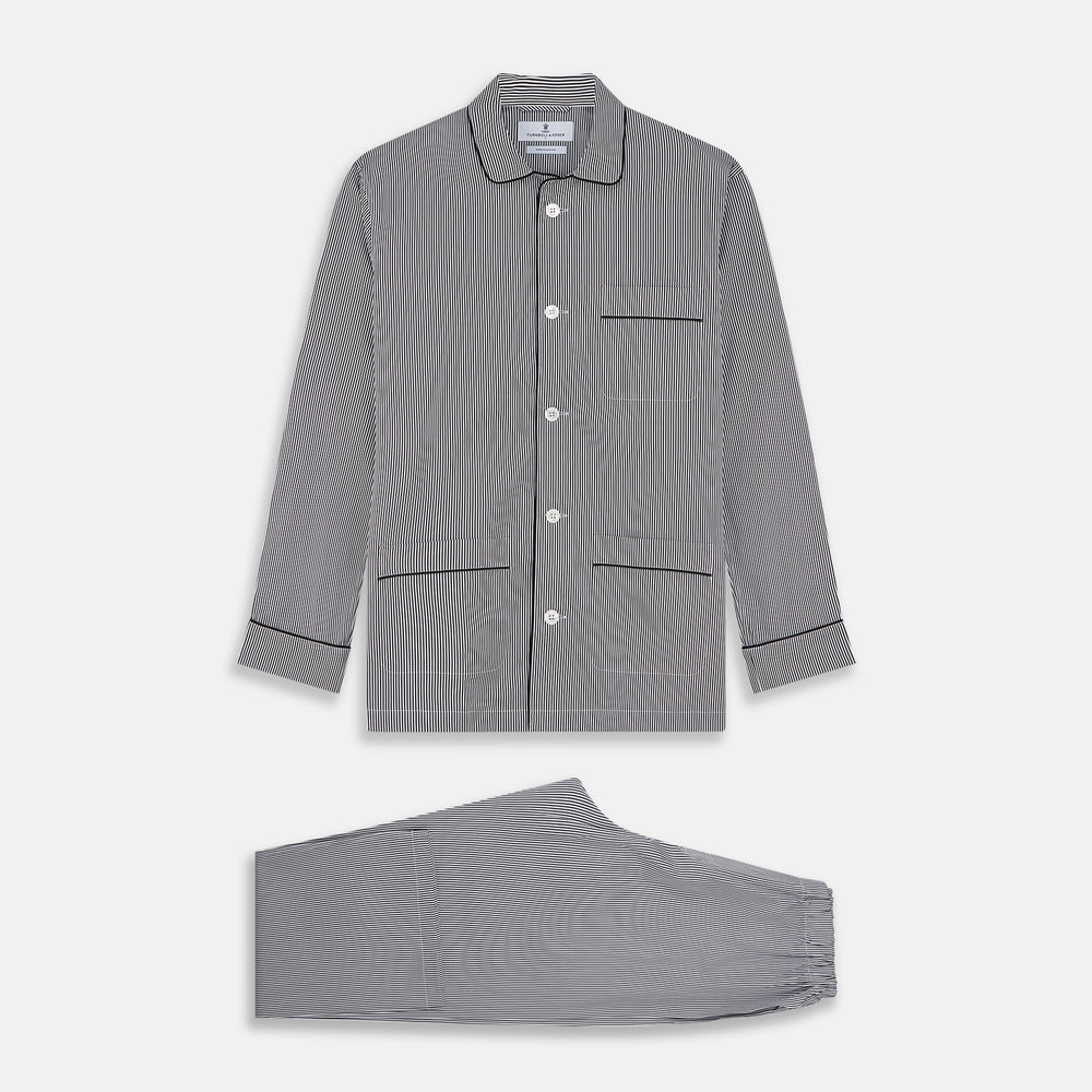 The Turnbull & Asser Black Candy Stripe Cotton Hyde Pyjama Set for men features soft cotton striped pajamas with a long-sleeve, button-up shirt detailed with black piping and three pockets, plus matching pants, both laid flat on a white background.
